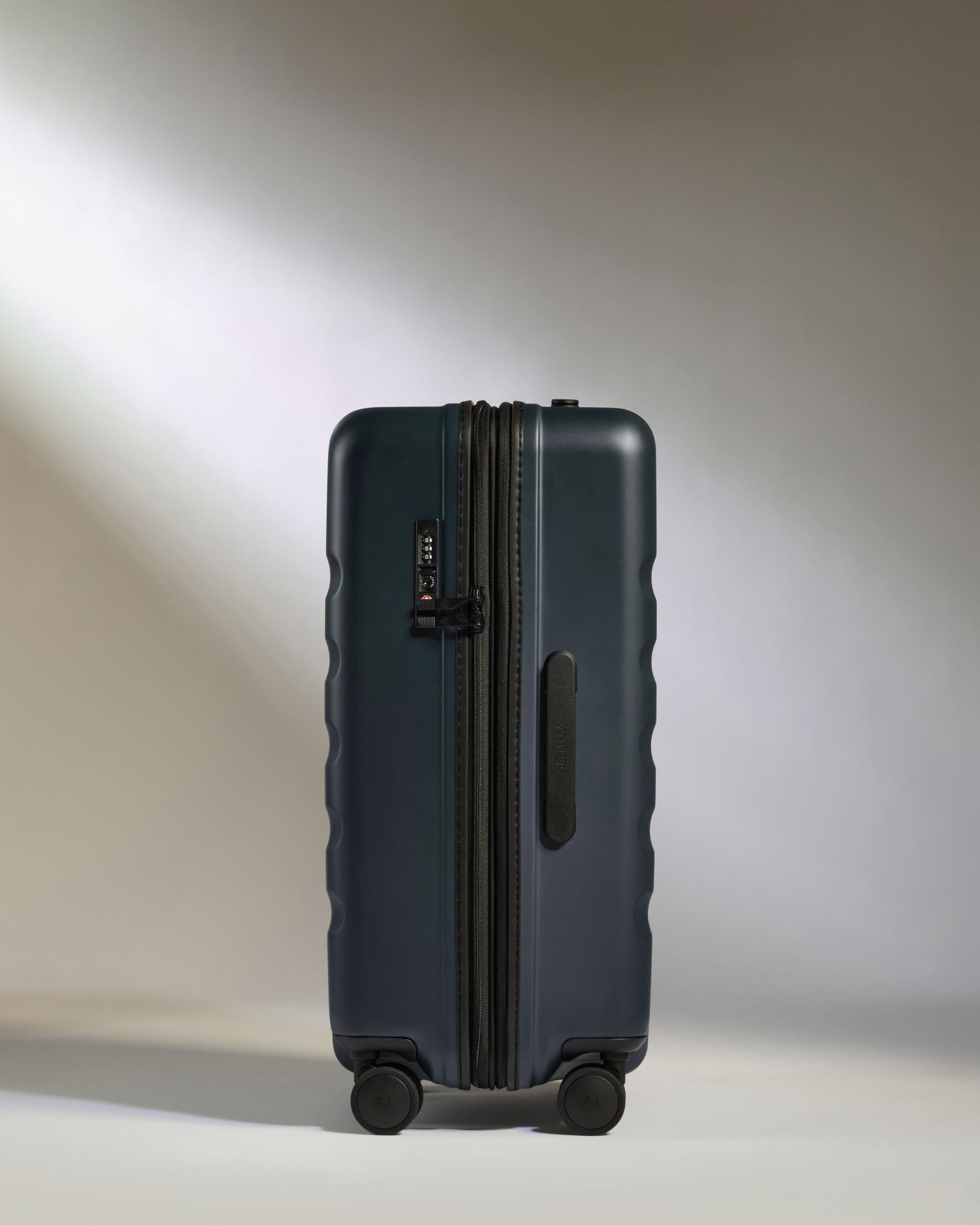 Medium suitcase in Navy - Icon Stripe | Lightweight & Hard Shell ...